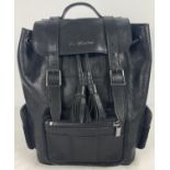 A Dr Martens black leather backpack with zipped pockets and suede detail. Cotton lined interior with