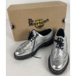 A pair of Dr Martens Kiltie metallic brogue shoes in silver santos leather. With removable kiltie
