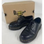 A pair of boxed Dr Martens smooth black leather shoes, 1461, with yellow stitching. Size 4, not