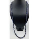 A 34" blue sodalite beaded necklace, made from round polished beads and chips. With a white metal