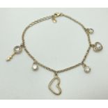 A silver gilt belcher chain bracelet with key, heart and circular drop charms. Some set with clear