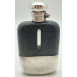 A vintage glass hip flask with silver plated detachable cup and leather bound top. Cork lined silver