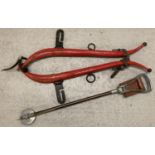 A painted red vintage metal horse harness together with a folding stick shooting seat. Harness