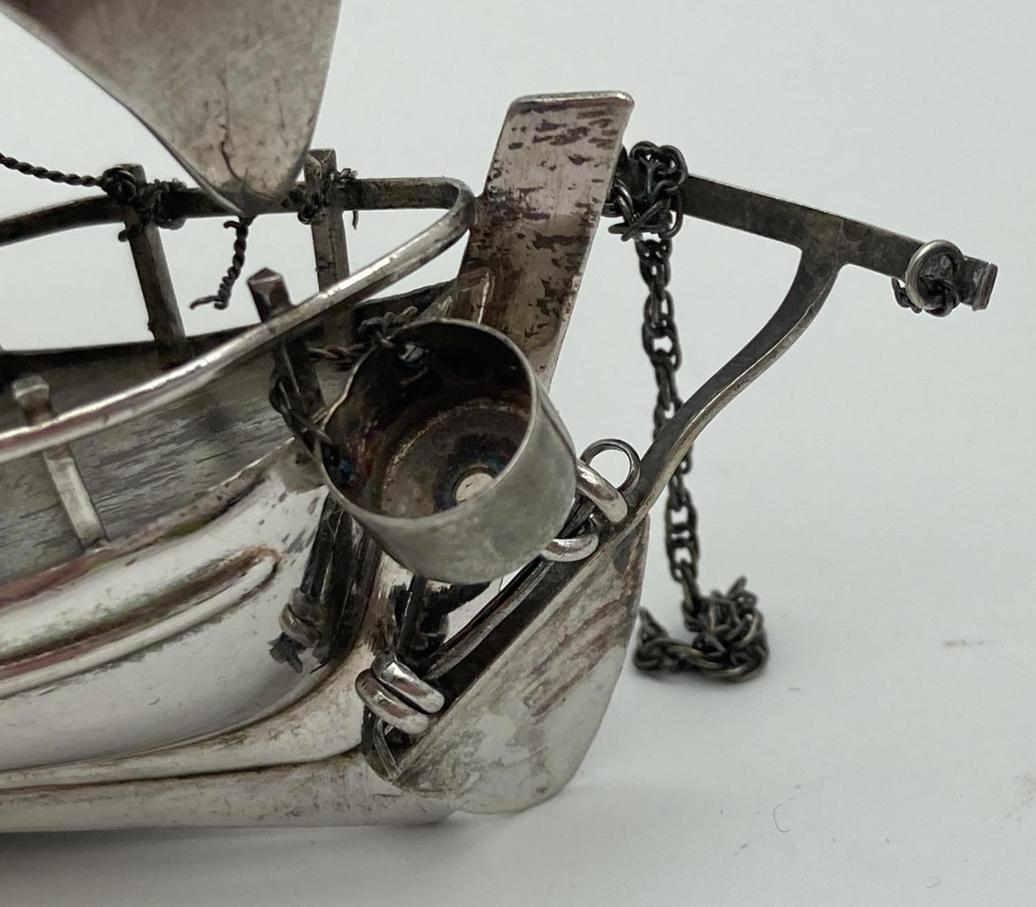 A vintage silver miniature sailing boat figurine with rudder, anchor and bailing bucket. Marked - Image 3 of 5