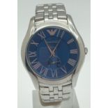 A men's stainless steel bracelet dress watch by Emporio Armani. Blue face with silver tone hour