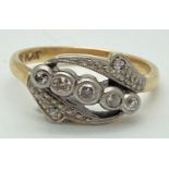An Edwardian 18ct gold, platinum set diamond ring with 5 central round cut stones. In an open