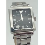 A men's wristwatch by Emporio Armani with square black face and stainless steel bracelet. Silver