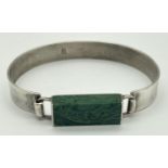 A modern design silver bracelet set with an oblong of green malachite. Hook and eye fastening.