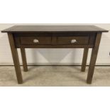 A modern wooden console table with two draws and leaf detail handles. Approx. 72.5 x 110 x 40cm.