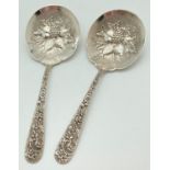 A pair of American silver serving spoons by S Kirk & Son Inc. With decoratively floral engraved