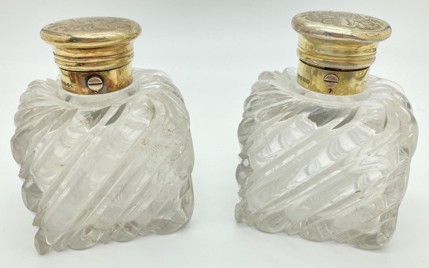 A pair of Victorian glass scent bottles with engraved silver gilt lids. Chunky square shaped glass