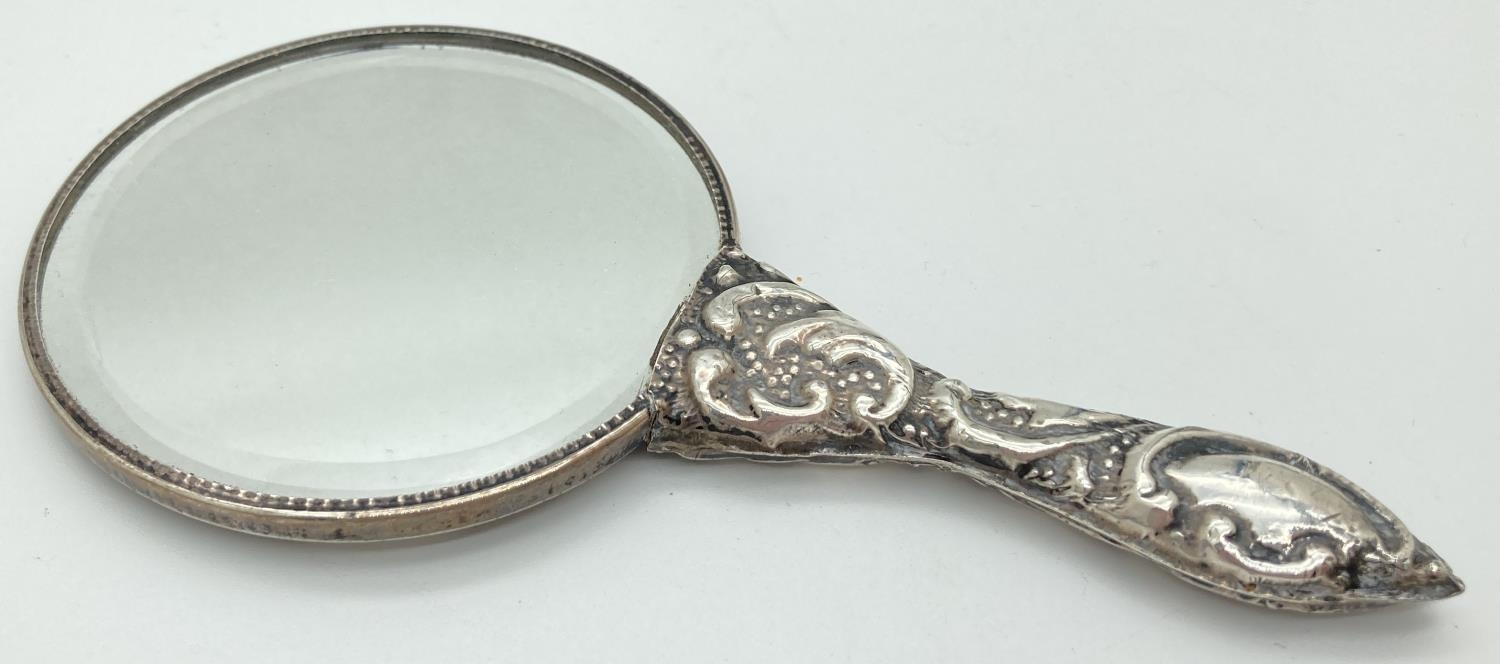 A small hand held 900 silver embossed mirror with scroll and foliate design. Approx. 14.5cm long, - Image 3 of 4