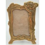 A small Art Nouveau style brass photo frame with female figure, butterfly and floral decoration.