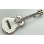 A 925 silver brooch in the shape of a guitar, complete with strings. Hallmarked to reverse.