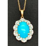 A 9ct gold pendant set with turquoise, pale blue and clear stones, on an 18" rope chain. Central