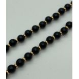 A vintage 14" beaded necklace with 18ct gold spring clasp and alternating black stone and 18ct