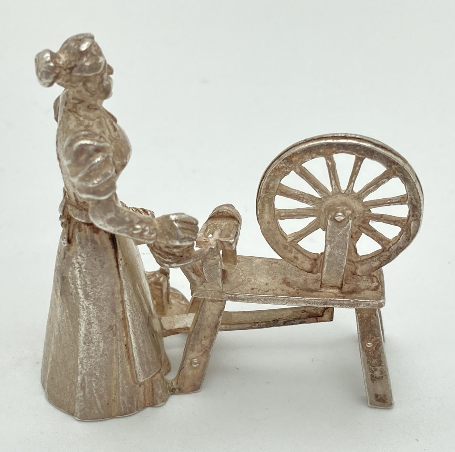 A vintage silver miniature model of a woman working a spinning wheel. Fully Hallmarked to base for - Image 2 of 4