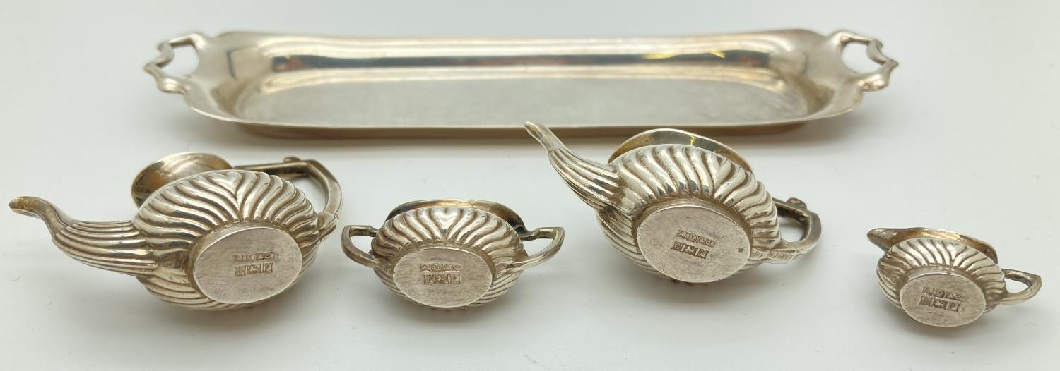 A hallmarked silver 5 piece miniature tea set of classical design. Comprising: water pot (with - Image 2 of 4