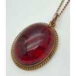 A vintage foil backed garnet mourning pendant in a 18ct gold rope design mount. On a later 17" 9ct