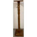 A vintage light wood torchere with turned pedestal and square shaped base and top. Approx. 116cm