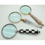 A collection of 3 large decorative handled magnifying glasses. 1 with curved faceted glass handle, 1