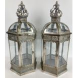 A large pair of modern Eastern style metal and glass panelled hexagonal lanterns with hinged