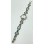 A ladies silver quartz wristwatch set with marcasites and malachite cabochons. With pierced detail