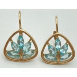 A pair of 9ct yellow gold earrings set with pale blue stones and with leverback fixings.