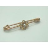 A vintage 9ct gold bar brooch with seed pearls set in a flower design. Safety pin style fixing.