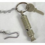 A vintage Hudson & Co Metropolitan Police whistle, numbered 22633. On a key ring with a police