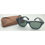 A pair of black Wayfarer sunglasses by Ray-Ban with plastic case and cleaning cloth. Ray-Ban name to