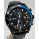 A men's chronograph 741407 wristwatch by Fossil with black leather strap. Black face with luminous