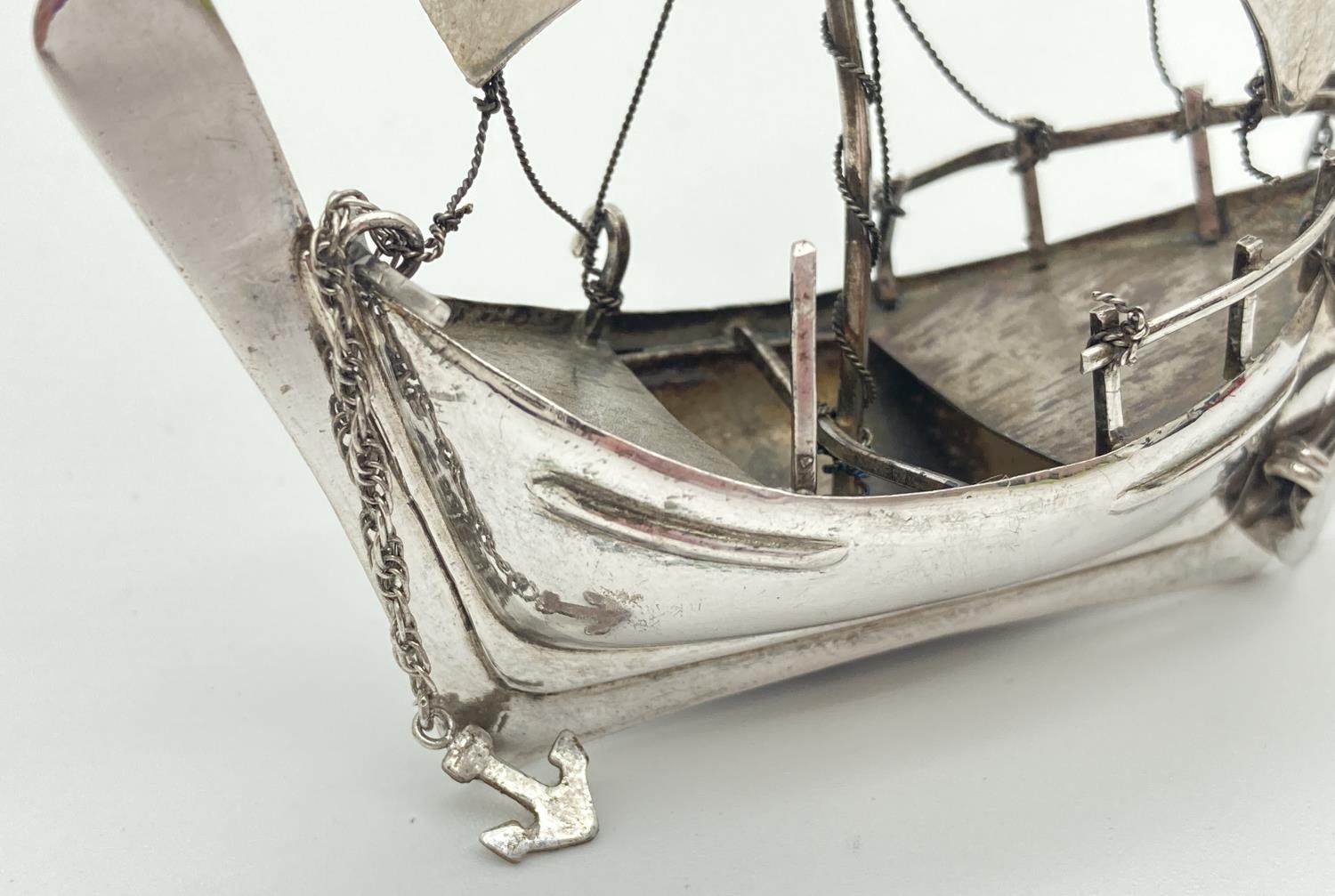 A vintage silver miniature sailing boat figurine with rudder, anchor and bailing bucket. Marked - Image 2 of 5