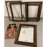 A collection of vintage wooden picture frames together with a dark oak framed mirror and a carved