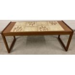 A 1970's teak tile top coffee table with wheat design, by Sunelm. Approx. 42 x 105 x 45.5cm.