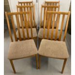 A set of 6 mid century light wood slat backed dining chairs. With curved seats covered in beige/