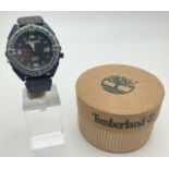 A men's Timberland Indiglo wristwatch with leather and canvas strap. Luminous hour markers and