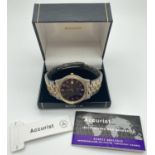 A boxed men's duo tone stainless steel bracelet wrist watch by Accurist. Black face with gold tone