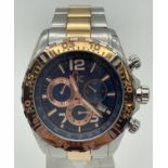 A men's Guess Collection chronograph wristwatch with two tone stainless steel strap and rotating