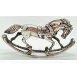 A vintage continental silver miniature model of a rocking horse. Indistinct hallmarks to tail and