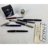 A collection of vintage fountain pens, a small glass inkwell and Parker ink. To include Conway 57