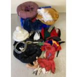 A box of assorted theatrical medieval styles hats, in varying styles and sizes.