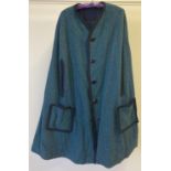 A vintage reversible wool mix cape with green and blue fleck tapestry style material to one side