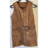 A vintage 1970's womens brown suede longline waistcoat with front zip fastening a square buckle