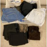 A large box of assorted mens shorts, jeans and trousers.