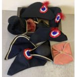 A box of assorted theatre costume hats to include 3 pointed and feathered examples.
