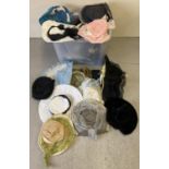 A large tub of assorted vintage and theatrical hats in varying colours and styles.