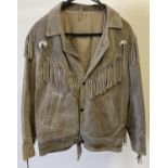 A 1980's western style, womens fringed brown suede jacket. Press stud fastening with 3 front