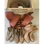 A large box of assorted men's vintage boots, in varying styles and sizes.