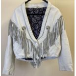 A 1980's womens soft white leather cowboy style short jacket with fringe and metal disc detail to